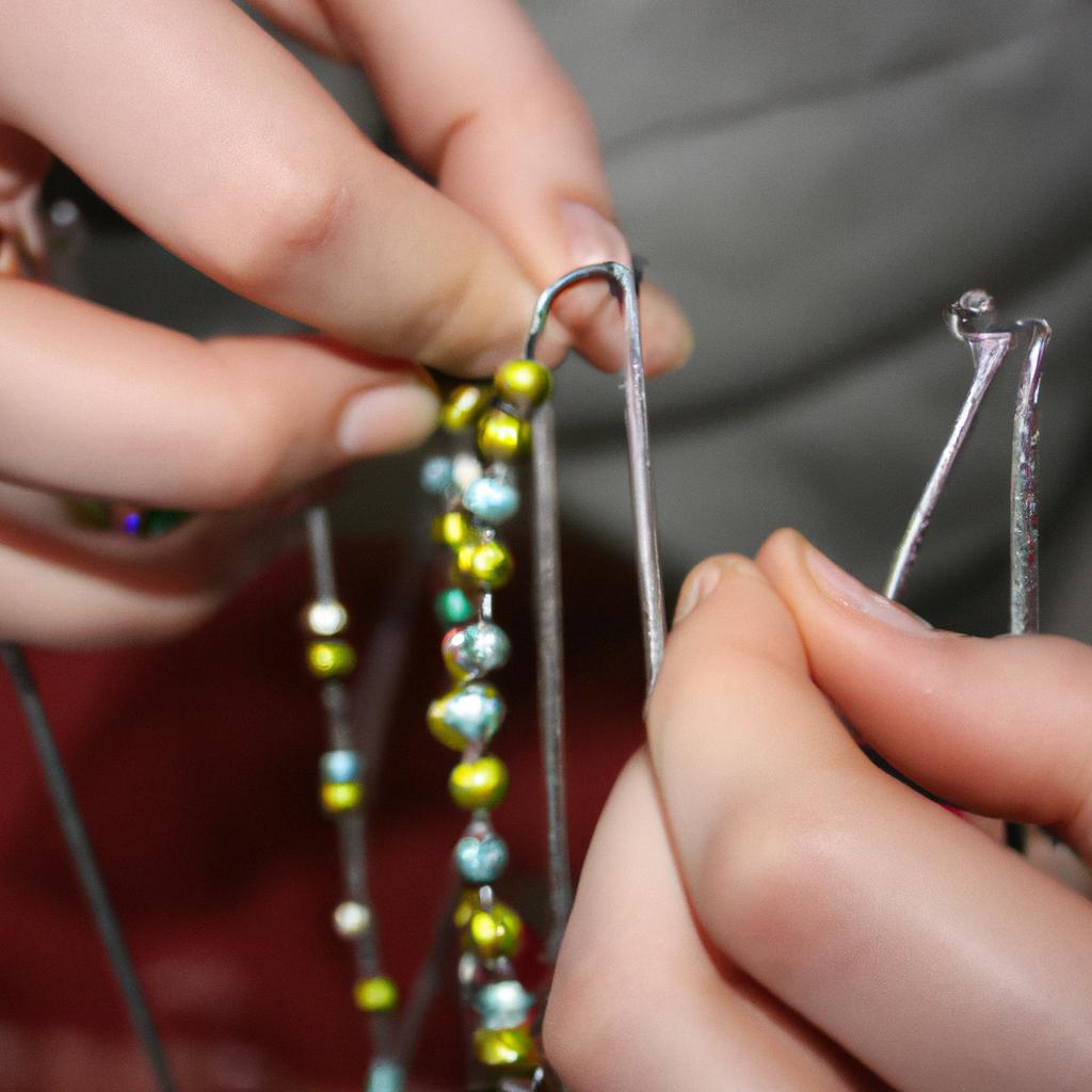 Person stringing beads on wire