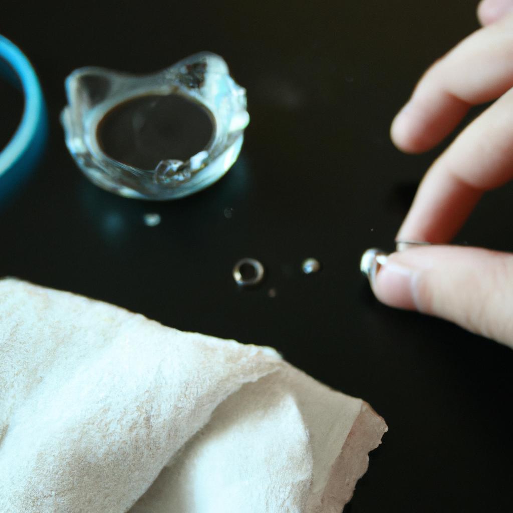 Person cleaning jewelry with cloth