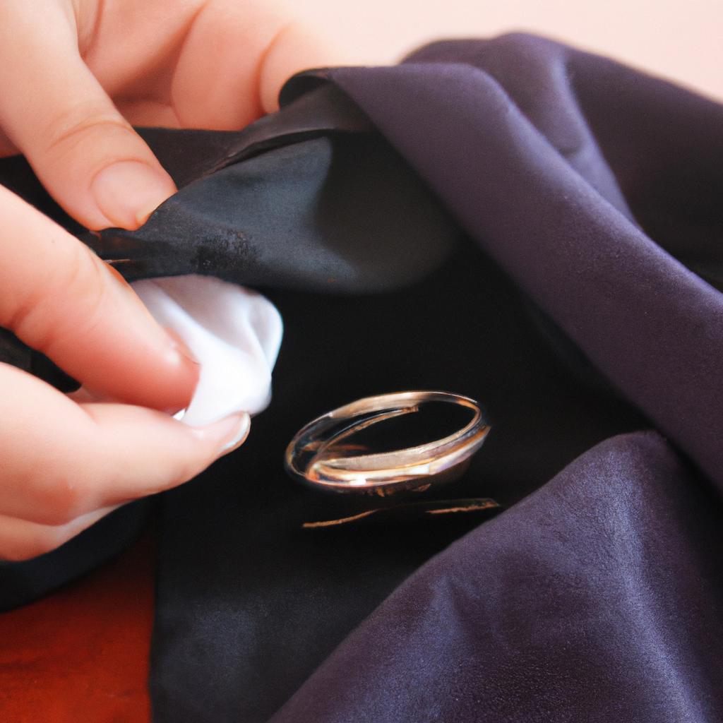 Person polishing jewelry with cloth